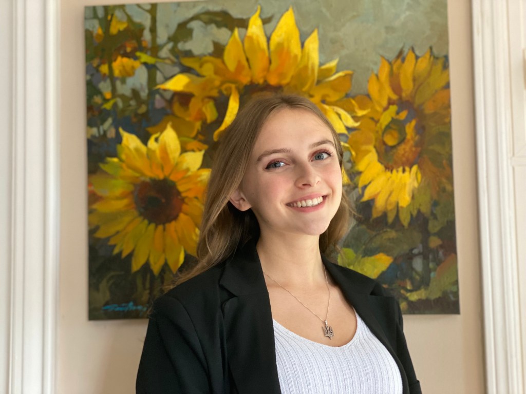 Alexandra standing in front of sunflower painting
